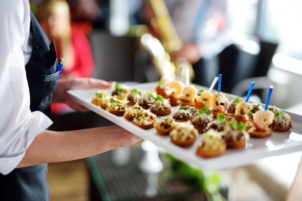 47847698 - waiter carrying plates with meat dish on some festive event, party or wedding reception